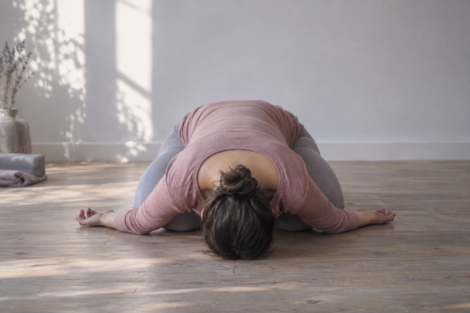 A kneeling forward fold with the forehead resting on the floor and the arms stretched out