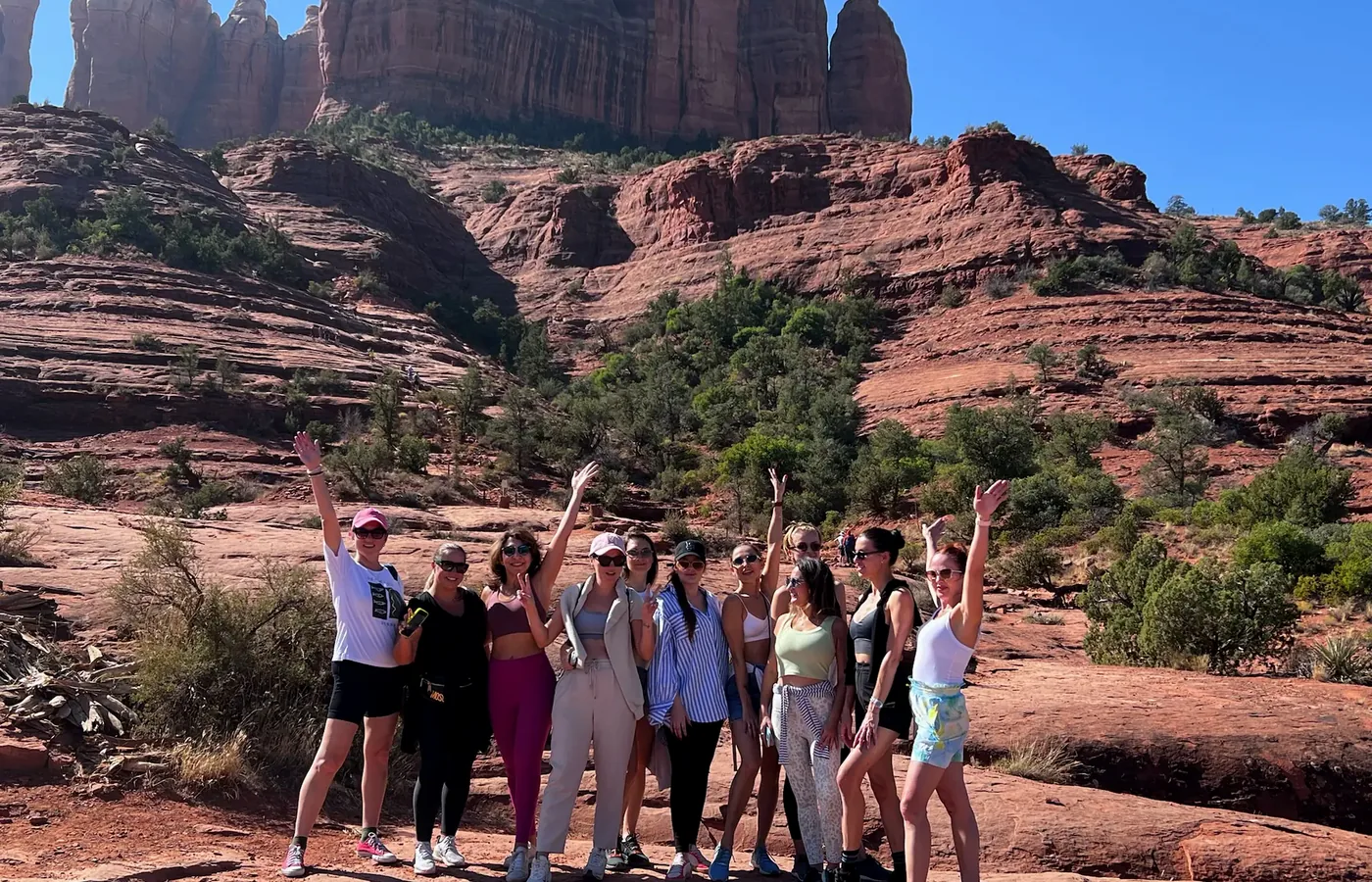 A group with Lexa among the red rocks