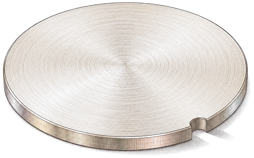 A small brass disc with one notch on its rim lying on a sheet of paper, the shadow of the notch beside it